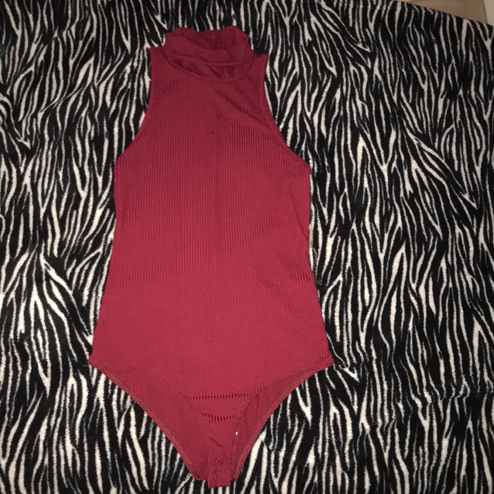 A ribbed bodysuit with a mid turtle neck